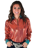 Woman wearing a rust metallic long sleeve zip top with turquoise collar and cuffs