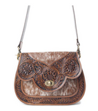 Western leather shoulder bag with cowhide accents displayed on a white background